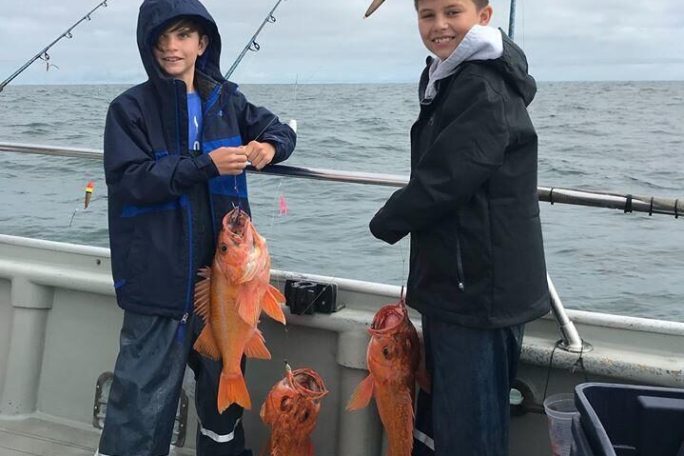 a couple of people that are standing in the water