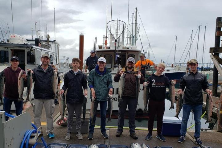 a group of people standing on a boat