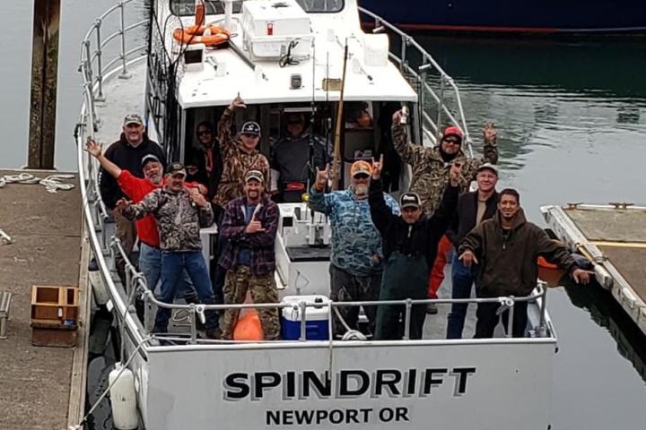 a group of people in a boat docked next to a body of water